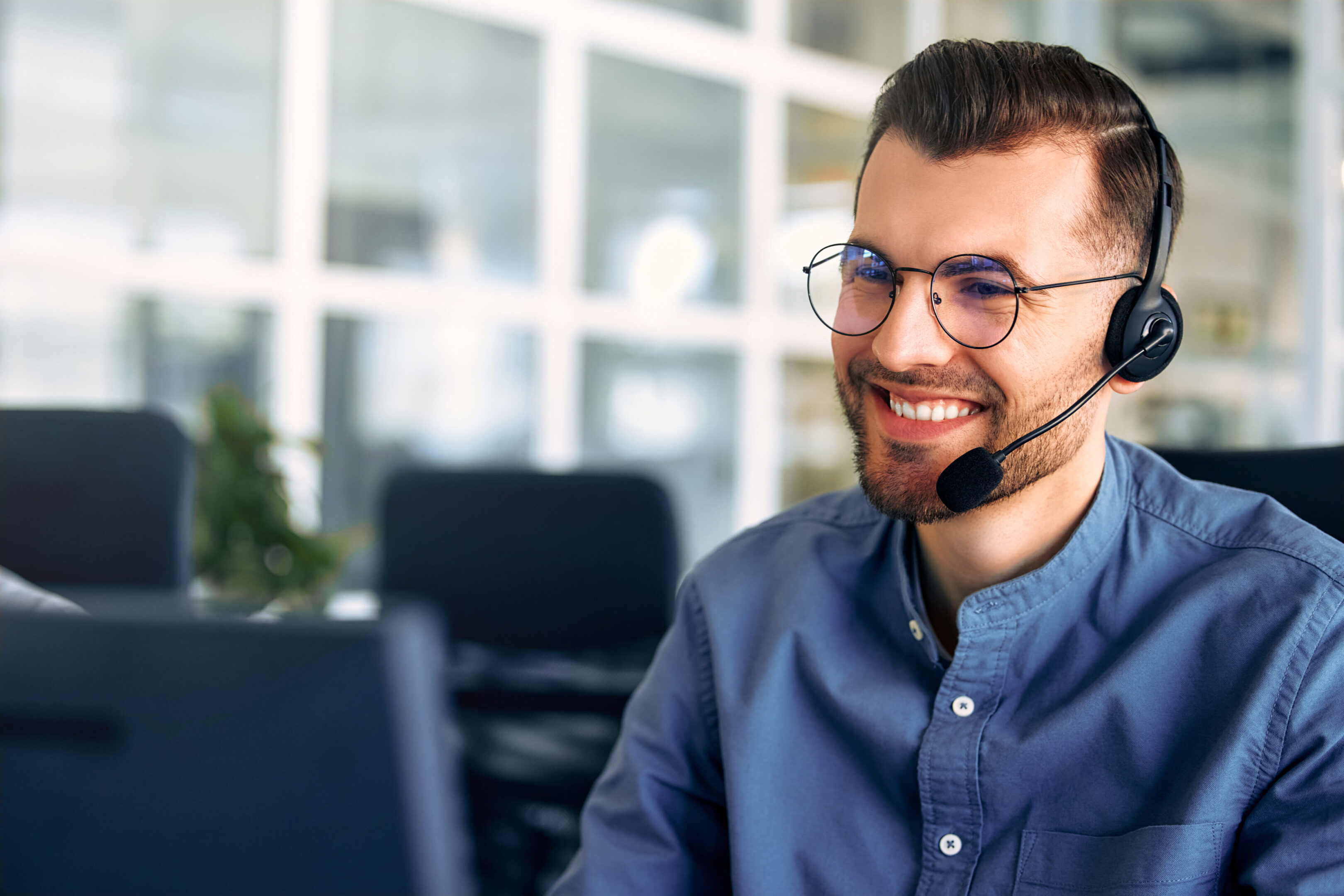 Man smiling while wearing a headset.